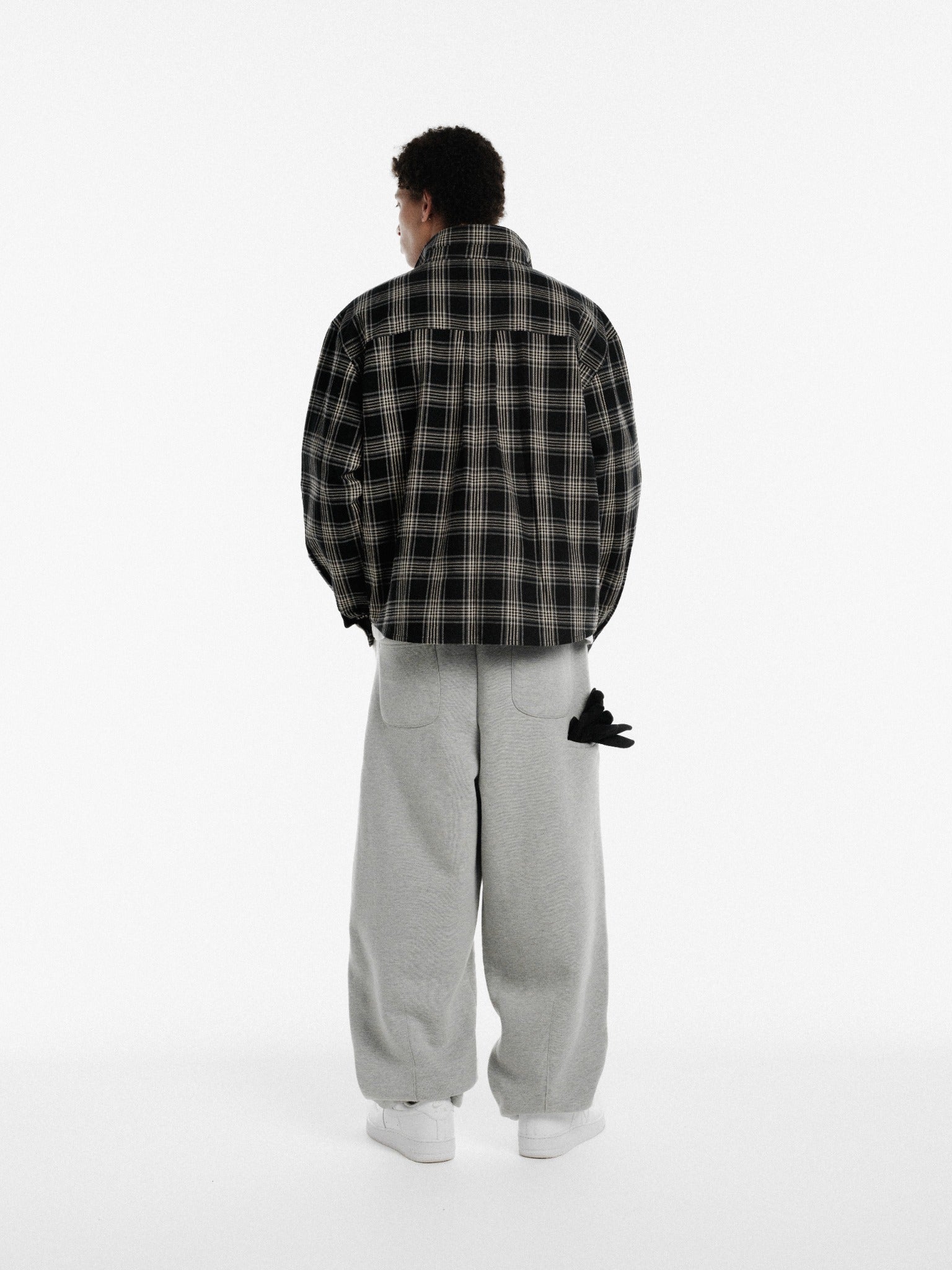 Black flannel long-sleeve shirt from Sweats UK featuring a classic plaid pattern and button-up front.