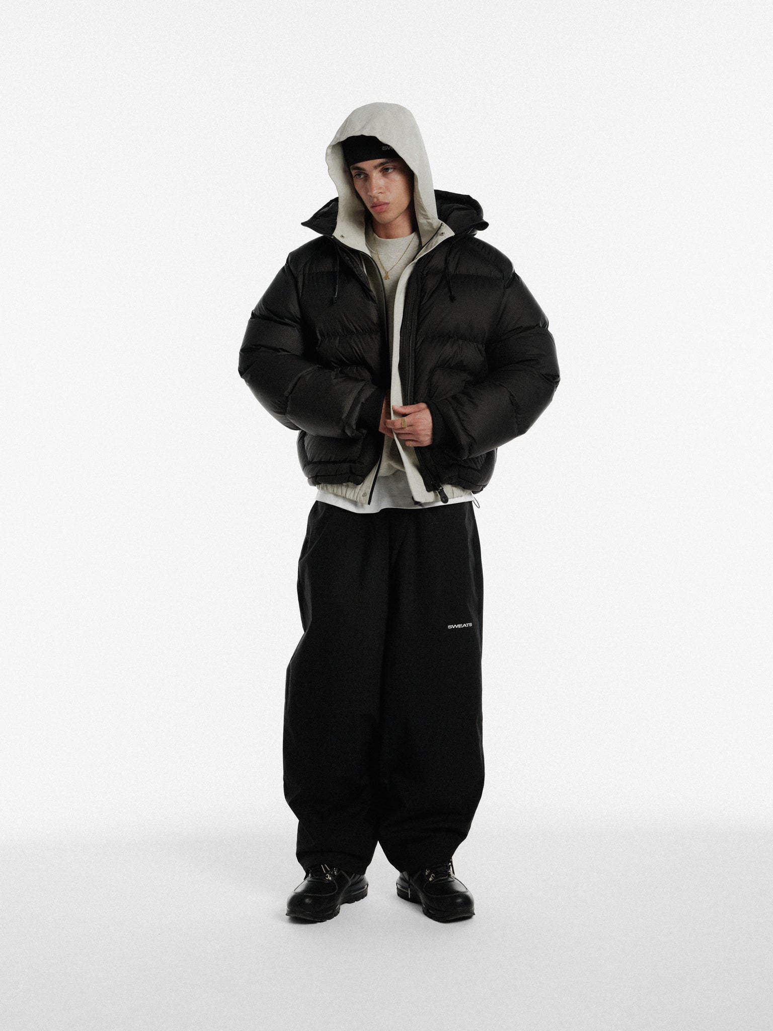 Sweats UK ARC Jacket in stone color, showcasing a stylish winter jacket with a front zipper and hood, ideal for cold weather.