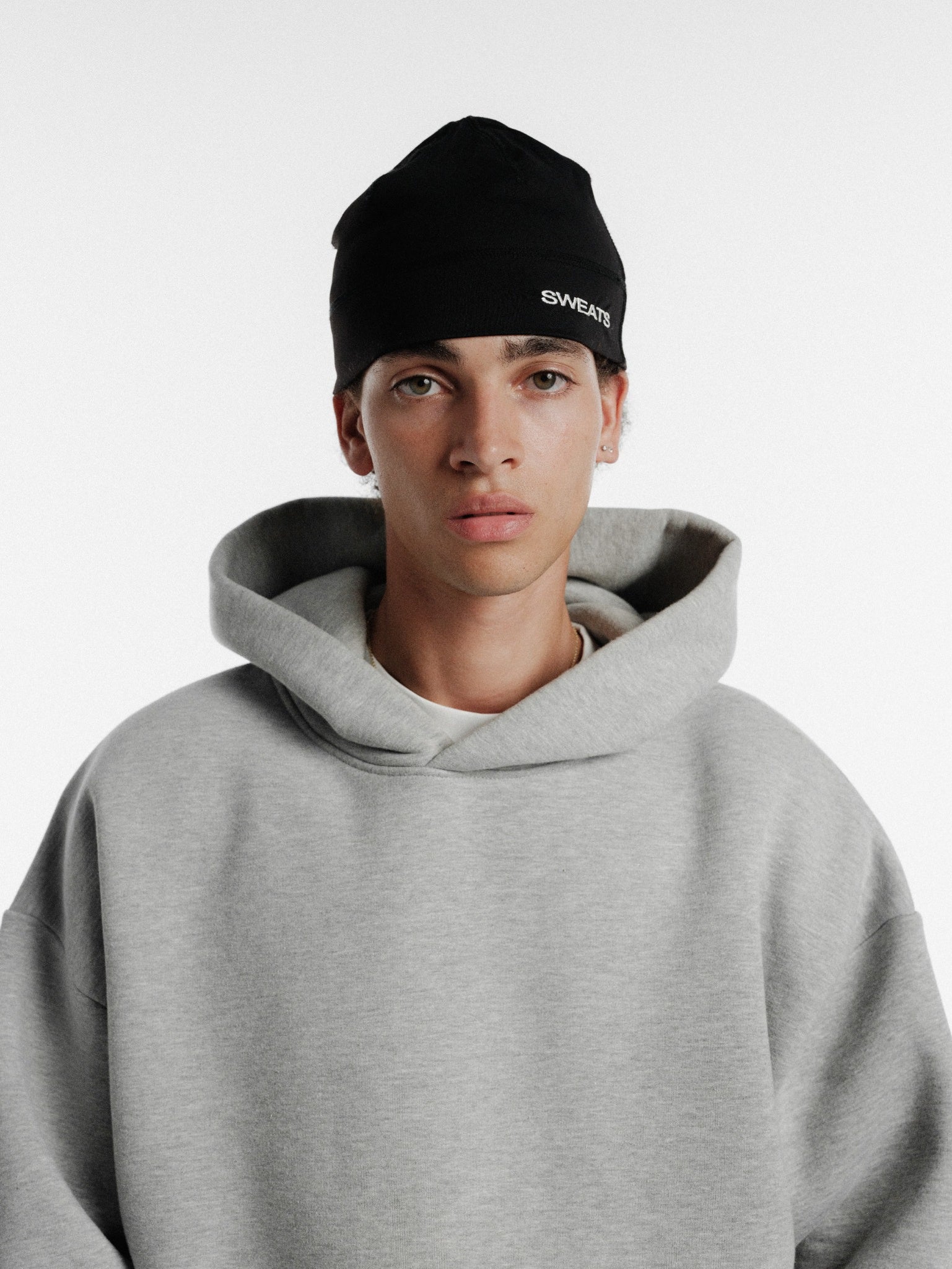 Black Sportskully hat by Sweats UK featuring a snug winter design and sporty style, shown on a plain background.