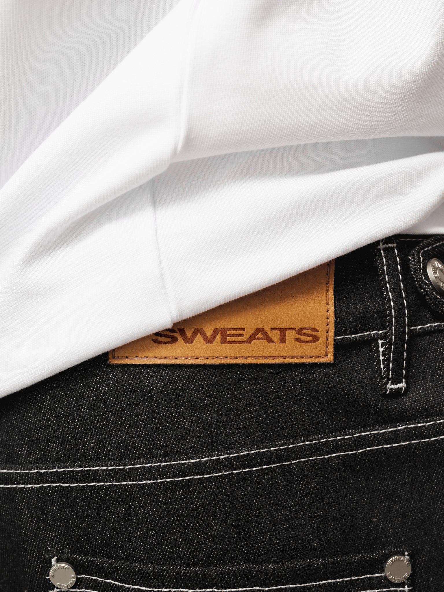 Black denim baggy jeans from Sweats UK with a relaxed fit, displayed on a plain background in a full-length shot.
