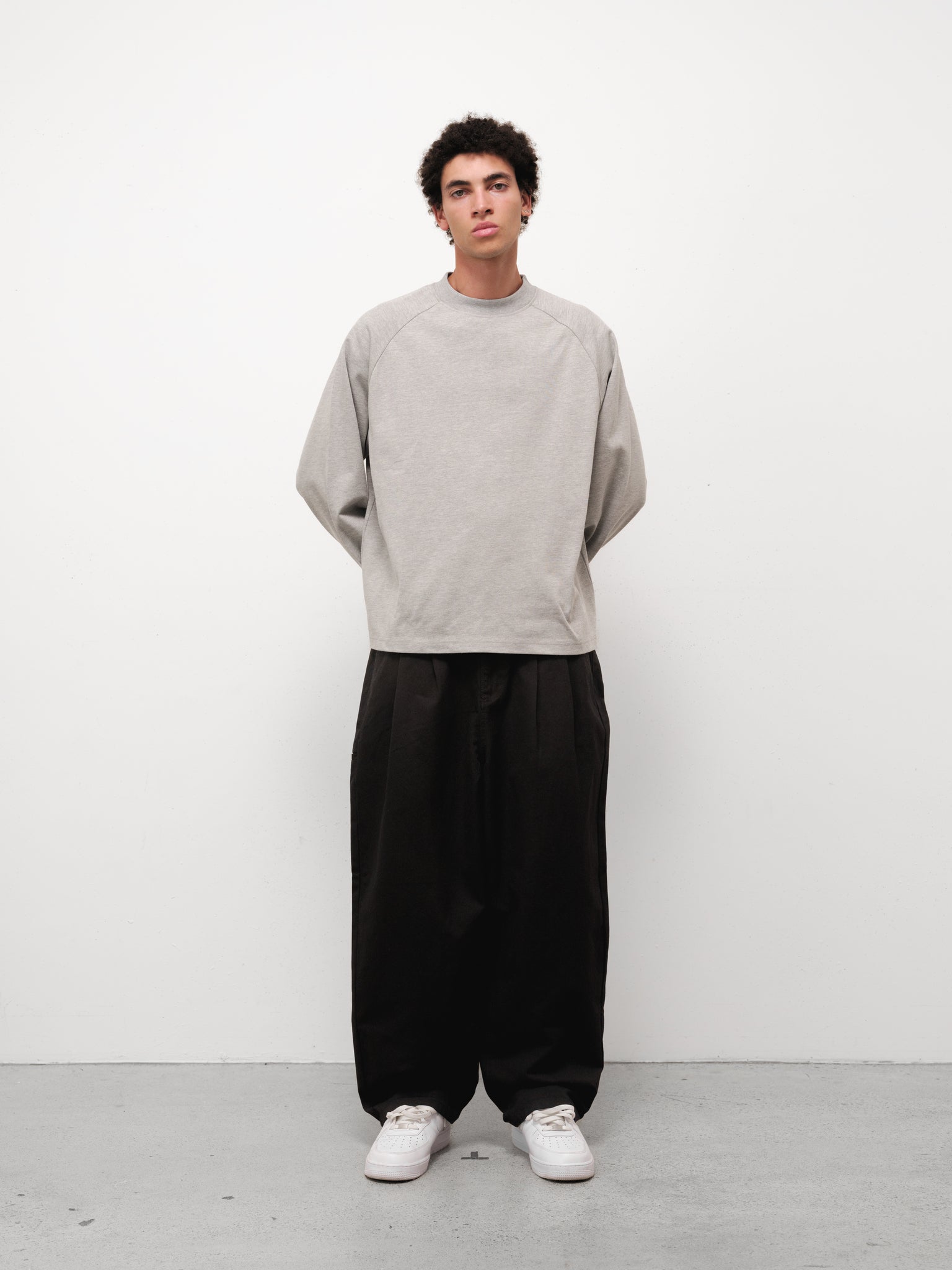 Grey long sleeve T-shirt from Sweats UK displayed on a model, showing front view and casual fit.