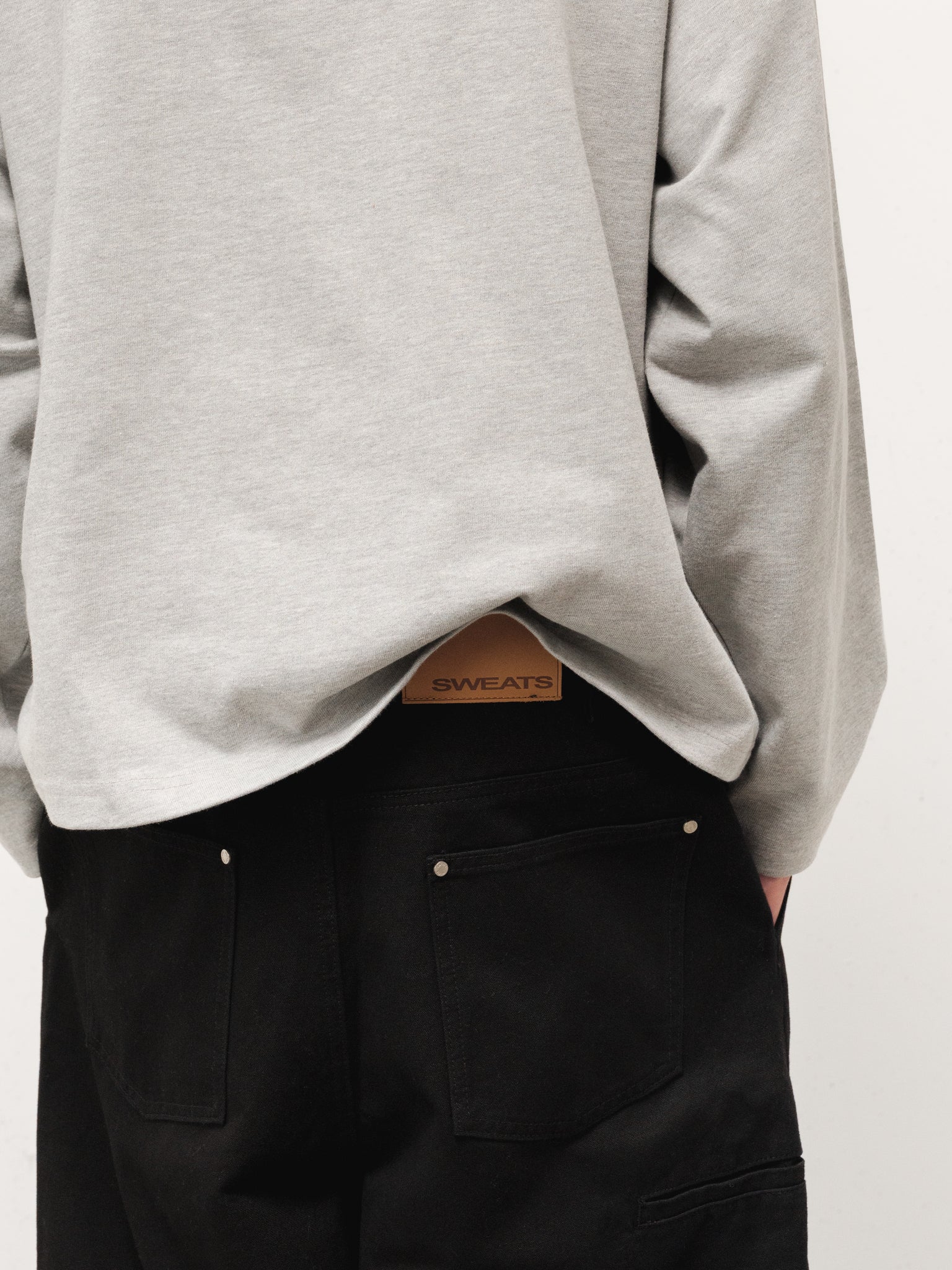 Grey long sleeve T-shirt from Sweats UK, shown on a model with a relaxed fit and soft fabric, perfect for casual wear.
