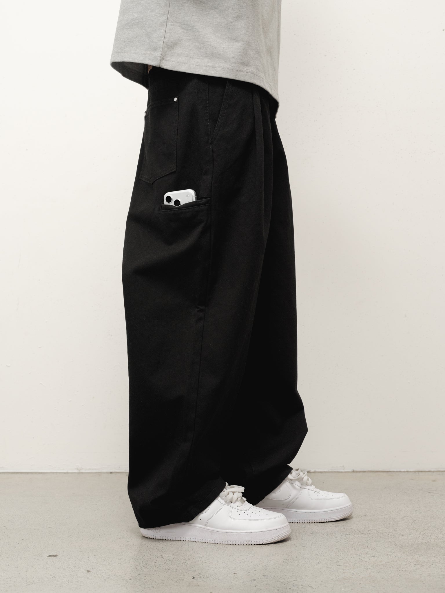 Black workwear pants by Sweats UK, shown in a full-stock shot, featuring a durable fit and practical design.
