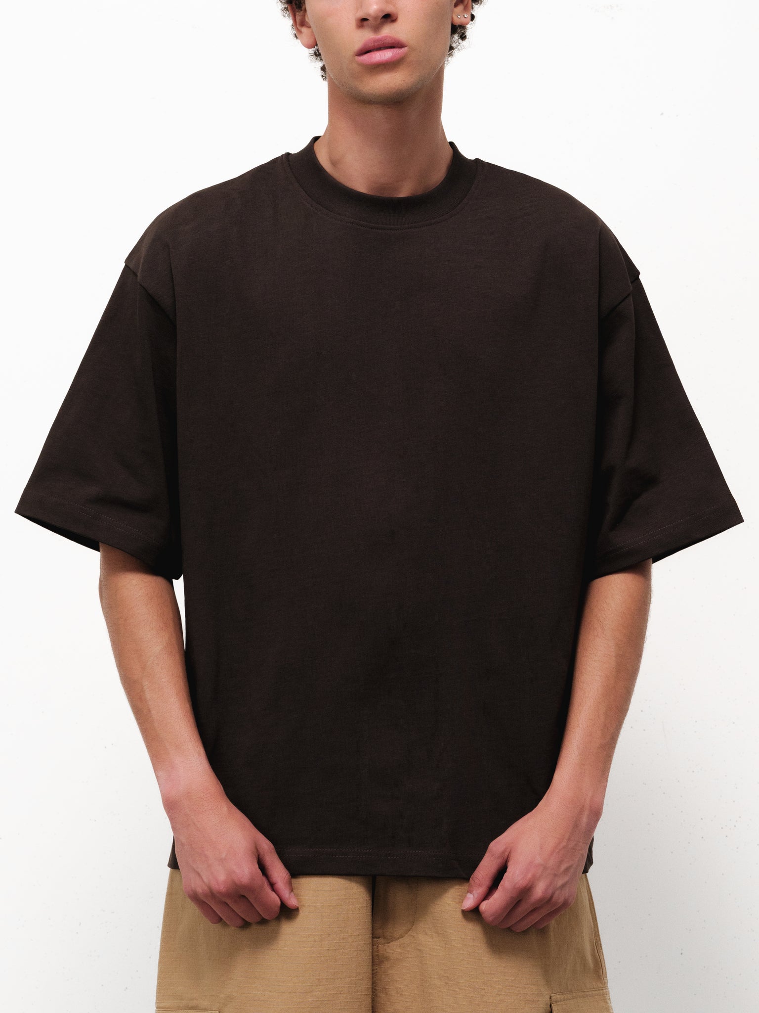 Sweats UK Signature Blank Coffee T-shirt displayed on a hanger, showing front view in a well-lit studio setting.