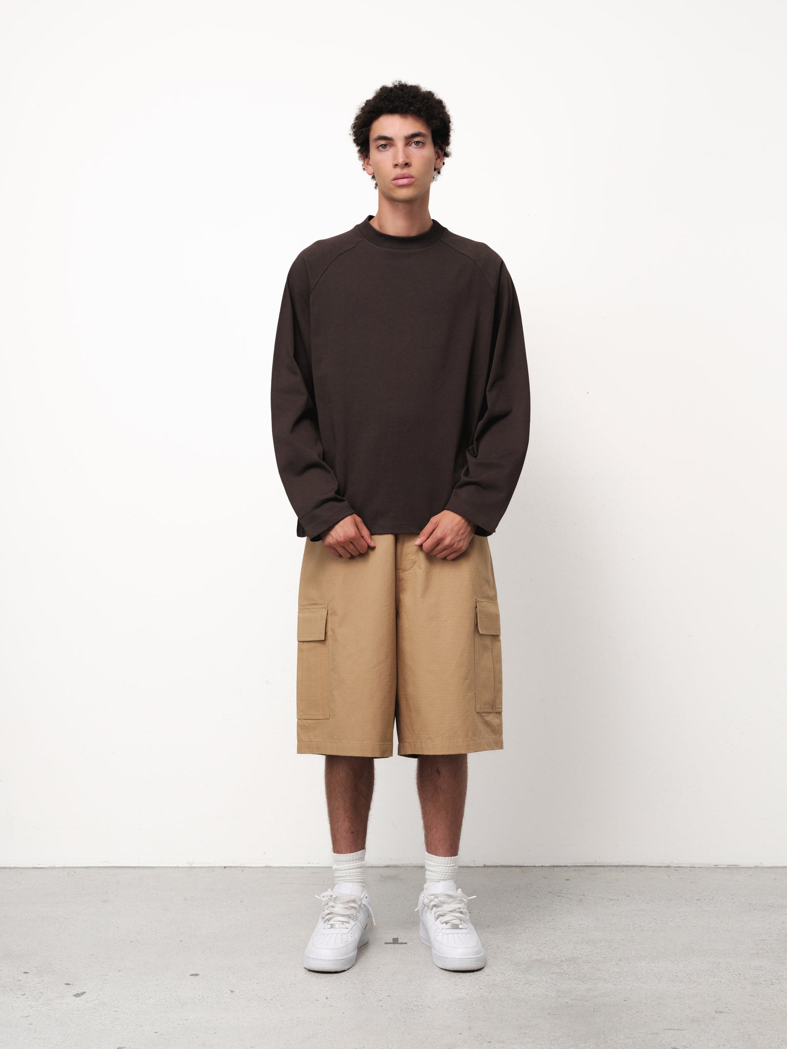 Long sleeve coffee-colored T-shirt by Sweats UK displayed on a hanger against a neutral background.