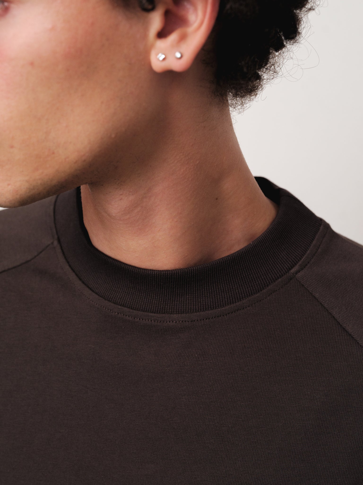 Long sleeve coffee-colored T-shirt by Sweats UK, shown on a model, featuring a comfortable fit and casual style.