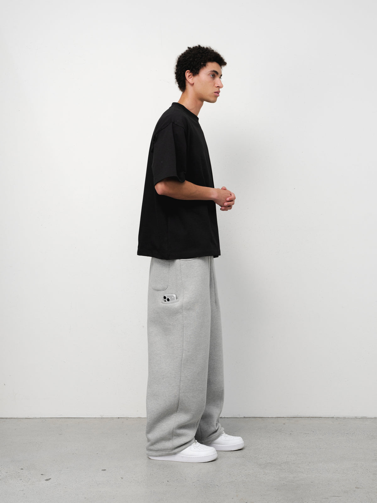 Black SIGNATURE BLANK T-shirt from Sweats UK displayed on a model, showcasing a simple, classic fit and soft fabric.