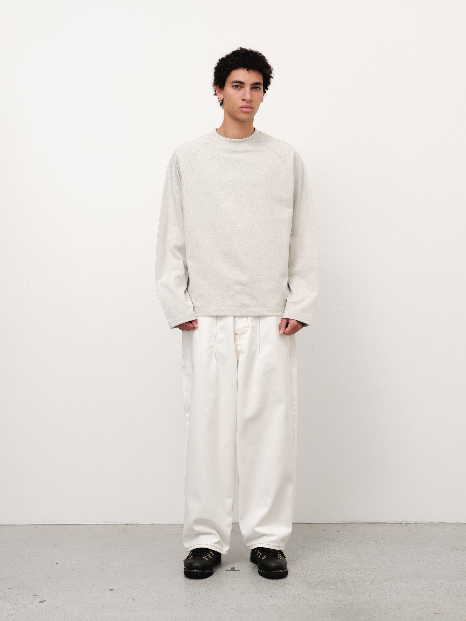 White denim baggy jeans by Sweats UK, displayed on a model with relaxed fit and classic five-pocket design.
