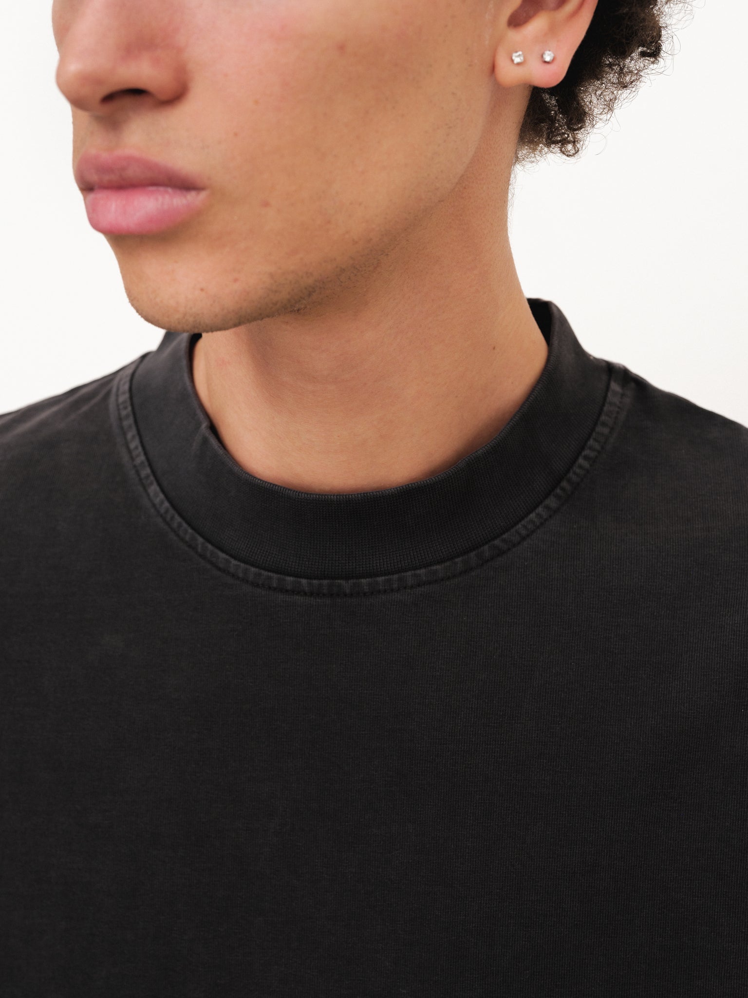 Sweats UK Signature Blank T-Shirt in washed black, displayed flat with a soft, worn-in fabric look and classic crew neck style.