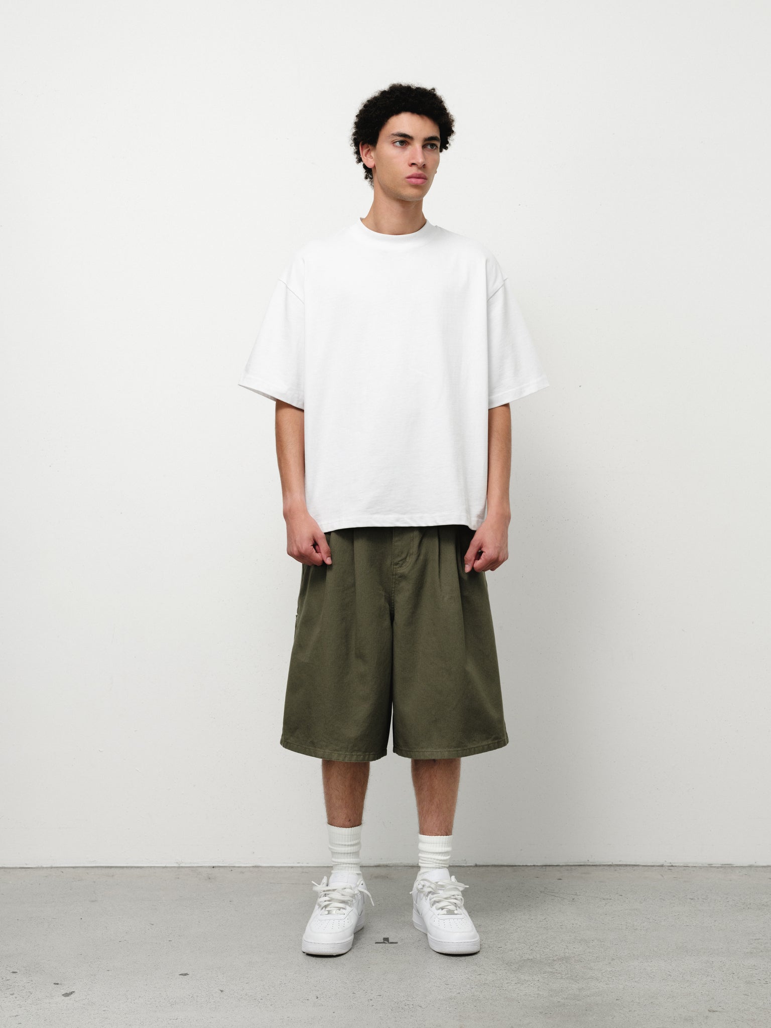 Olive workwear shorts by Sweats UK, shown on model, featuring durable fabric and practical design for industrial or outdoor tasks.