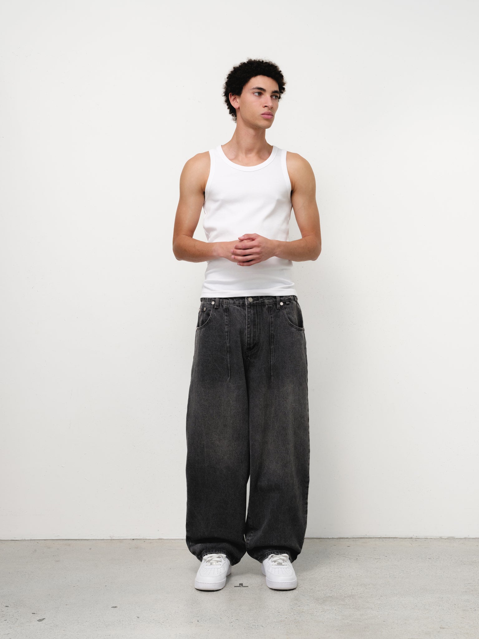 White tank singlet by Sweats UK, front view showing sleeveless design and soft fabric for casual wear.